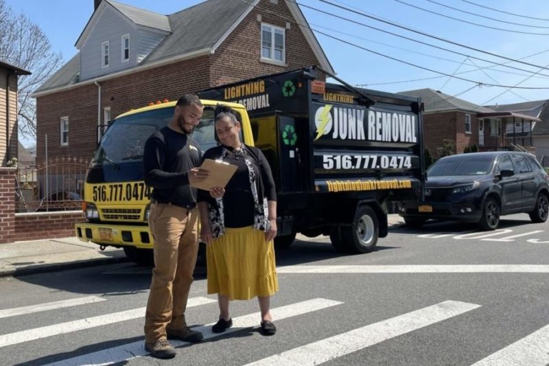 junk removal pro smiling with happy customer