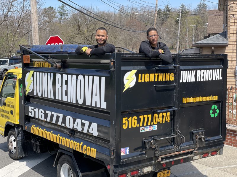 Junk removal professionals posing in the truck