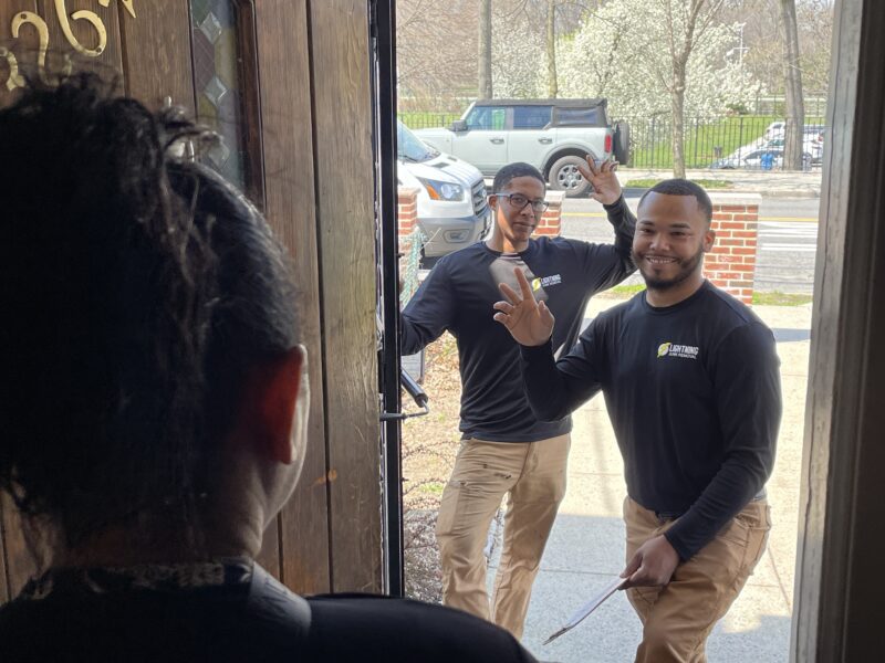Junk removal professionals greeting a customer at the door before junk removal services in Throgs Neck