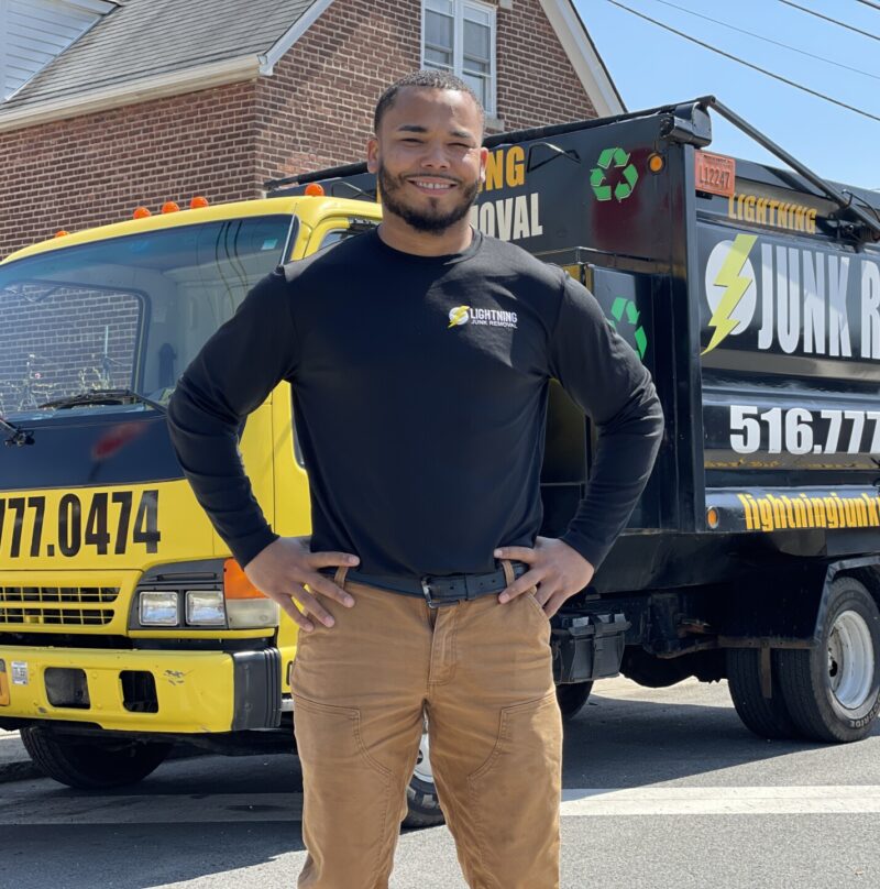 Junk removal professional smiling before providing valet trash pickup services