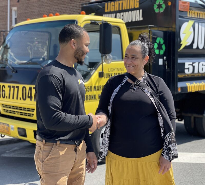Lightning Junk Removal professional shaking hands with a happy customer after providing junk removal services in Mamaroneck, NY